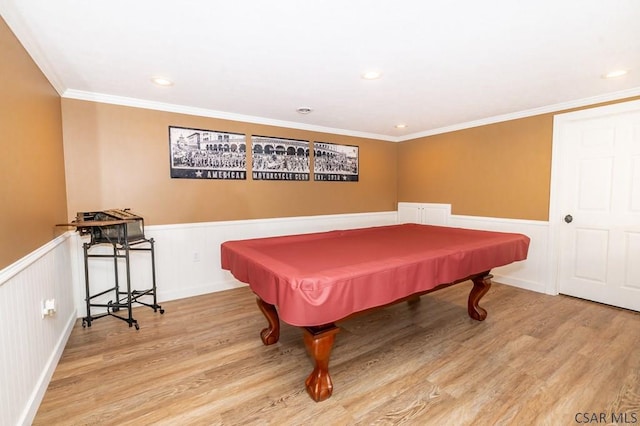 recreation room with ornamental molding, pool table, and light wood-type flooring