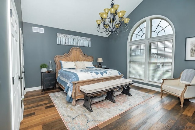 bedroom with an inviting chandelier, vaulted ceiling, and dark hardwood / wood-style floors