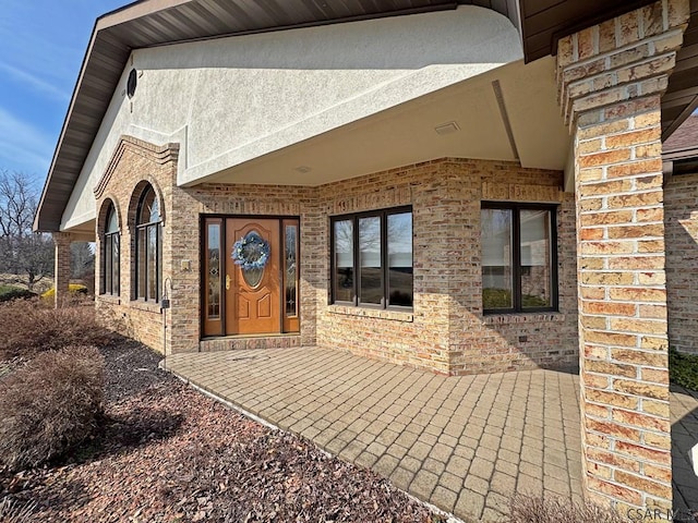 property entrance featuring brick siding