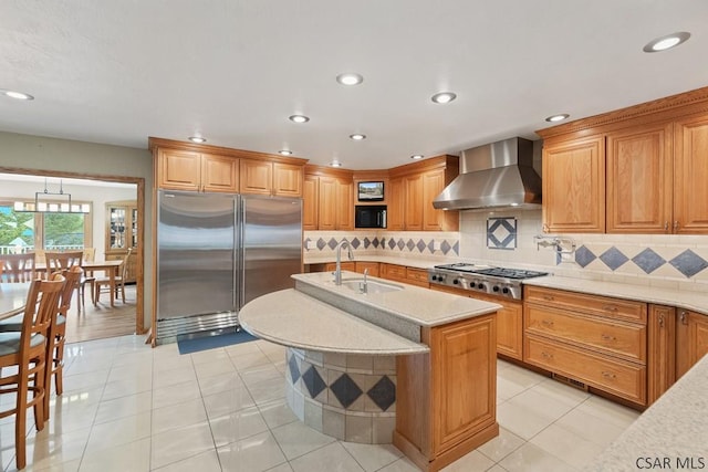 373 Hillside Ln, Somerset, PA 15501 - kitchen with stainless steel appliances, a sink, wall chimney exhaust hood, tasteful backsplash, and an island with sink