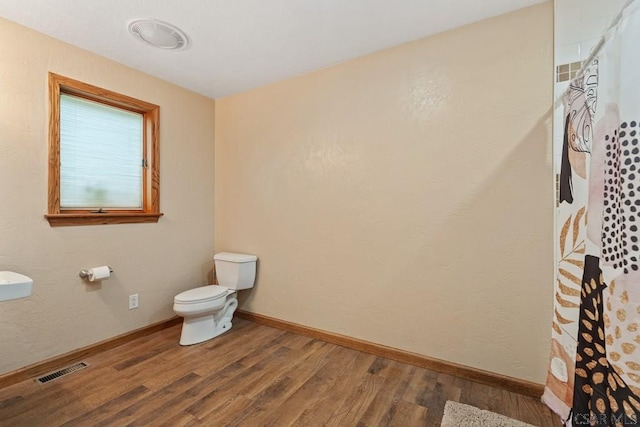 373 Hillside Ln, Somerset, PA 15501 - full bathroom featuring toilet, wood finished floors, curtained shower, and baseboards