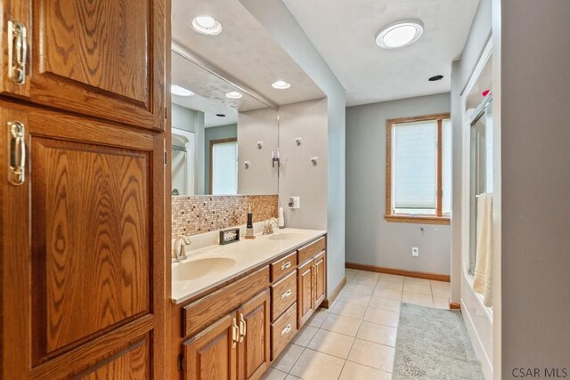 373 Hillside Ln, Somerset, PA 15501 - bathroom with tile patterned floors, double vanity, decorative backsplash, baseboards, and recessed lighting