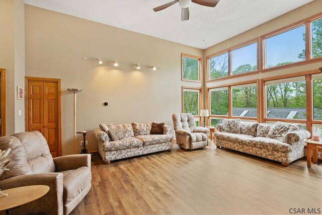373 Hillside Ln, Somerset, PA 15501 - living room featuring ceiling fan, a high ceiling, and light wood finished floors