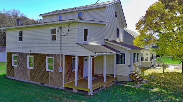 rear view of property featuring a yard