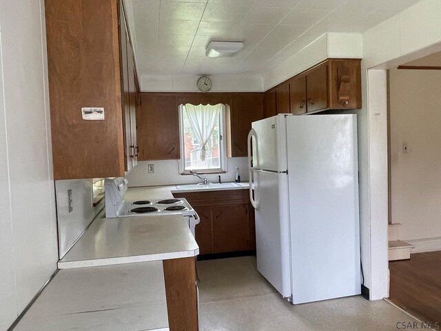 504 Swank St, Johnstown, PA 15905 - kitchen featuring white appliances, light countertops, and brown cabinets