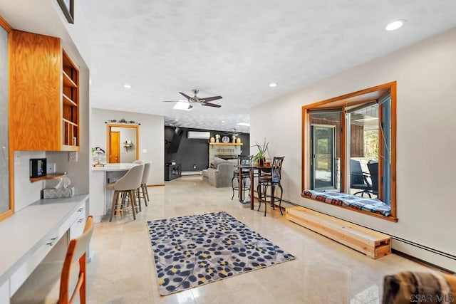 living room featuring recessed lighting, a fireplace, baseboards, and a ceiling fan