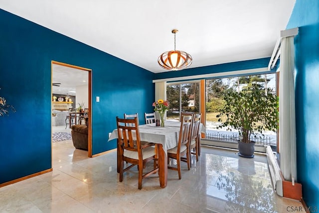 dining area featuring baseboards and marble finish floor