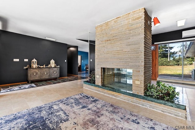 unfurnished living room with baseboards, a brick fireplace, a wall mounted AC, and tile patterned flooring