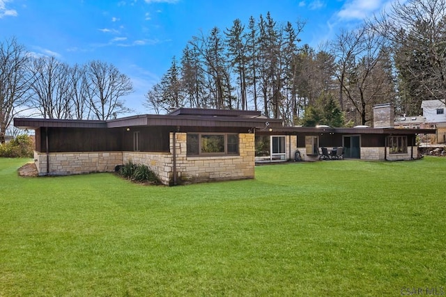 rear view of house featuring a yard