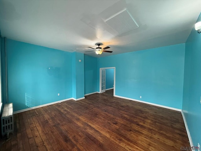 empty room featuring a ceiling fan, baseboards, and hardwood / wood-style floors