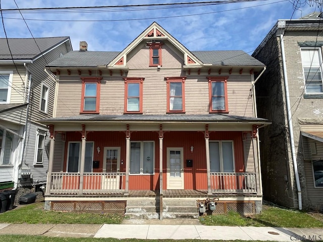 view of front of house featuring covered porch and a chimney