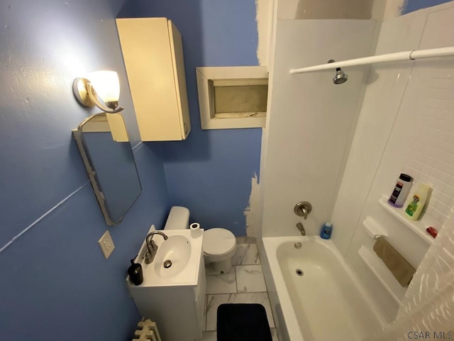 bathroom with toilet, marble finish floor, vanity, and bathing tub / shower combination