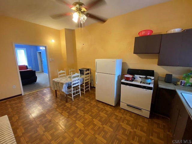 kitchen with ceiling fan, light countertops, white appliances, and a sink