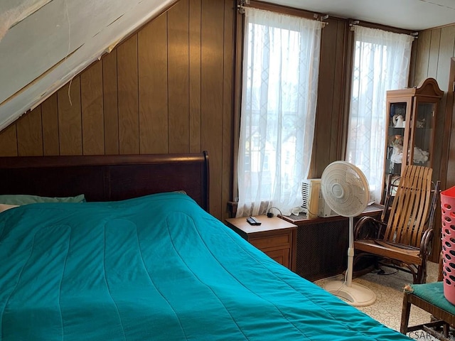 bedroom with wood walls and carpet
