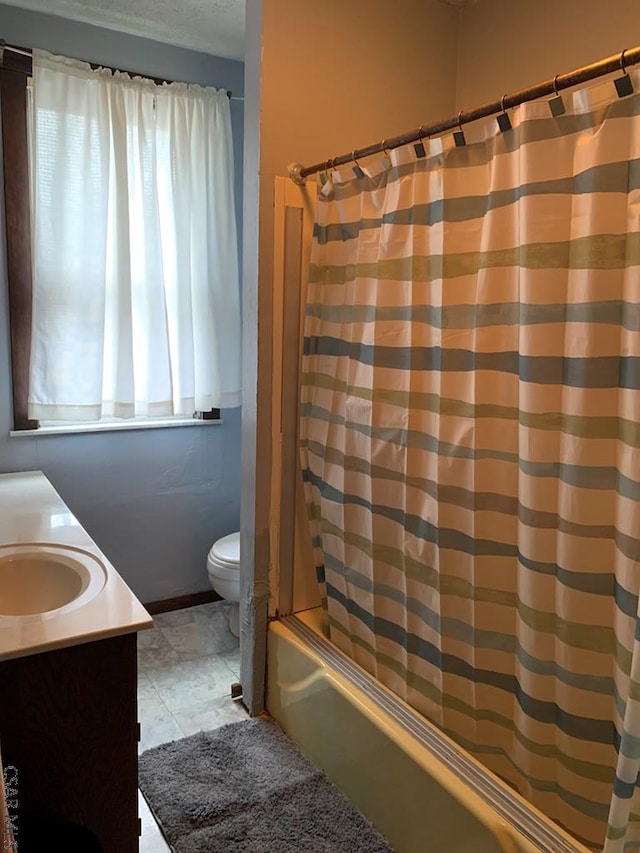full bathroom featuring shower / bathtub combination with curtain, toilet, and vanity