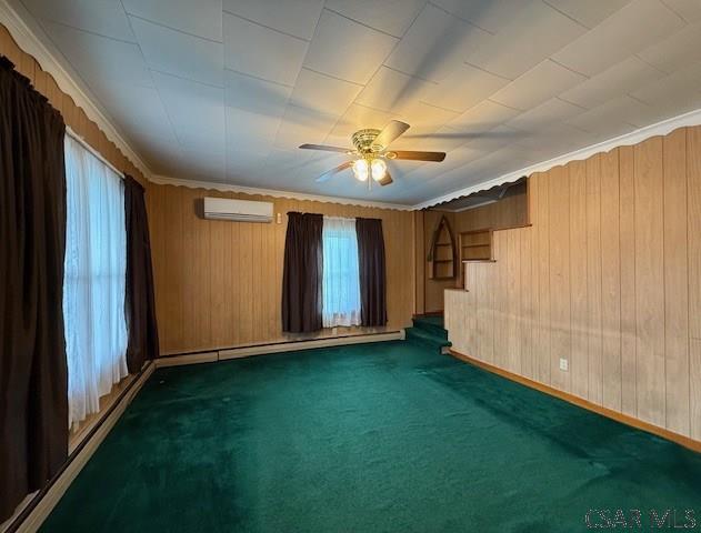 201 7th St, Windber, PA 15963 - spare room with a wall mounted air conditioner, carpet floors, ceiling fan, stairs, and wooden walls