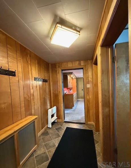 201 7th St, Windber, PA 15963 - mudroom with wooden walls and dark tile patterned flooring