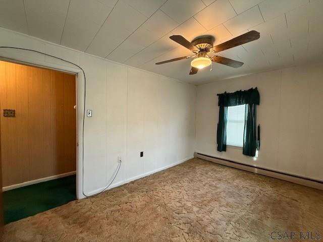 201 7th St, Windber, PA 15963 - spare room with a baseboard heating unit, carpet, a ceiling fan, and baseboards