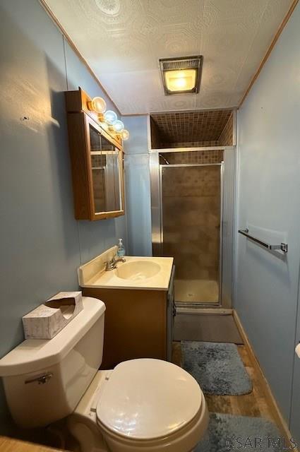 201 7th St, Windber, PA 15963 - full bathroom featuring toilet, a shower stall, vanity, and wood finished floors