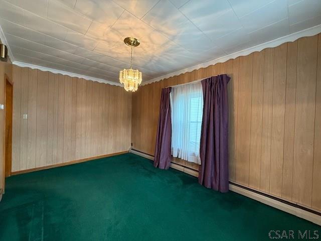 201 7th St, Windber, PA 15963 - carpeted empty room featuring a chandelier, wood walls, and baseboard heating