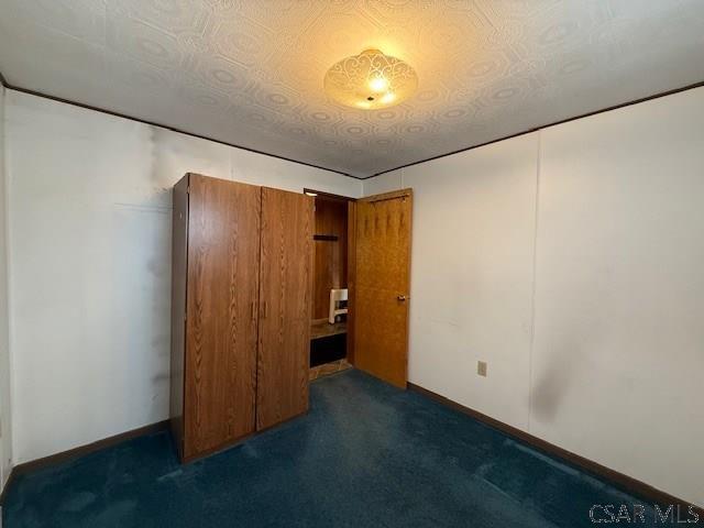 201 7th St, Windber, PA 15963 - unfurnished bedroom featuring carpet and baseboards