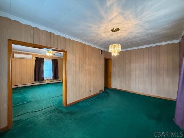 201 7th St, Windber, PA 15963 - carpeted spare room featuring an AC wall unit, a chandelier, baseboard heating, and wood walls