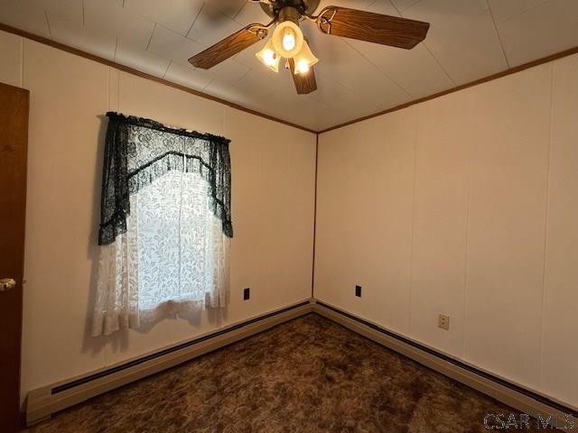 201 7th St, Windber, PA 15963 - empty room featuring crown molding, a ceiling fan, and baseboard heating