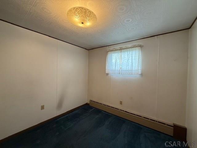 201 7th St, Windber, PA 15963 - spare room featuring baseboard heating and a textured ceiling