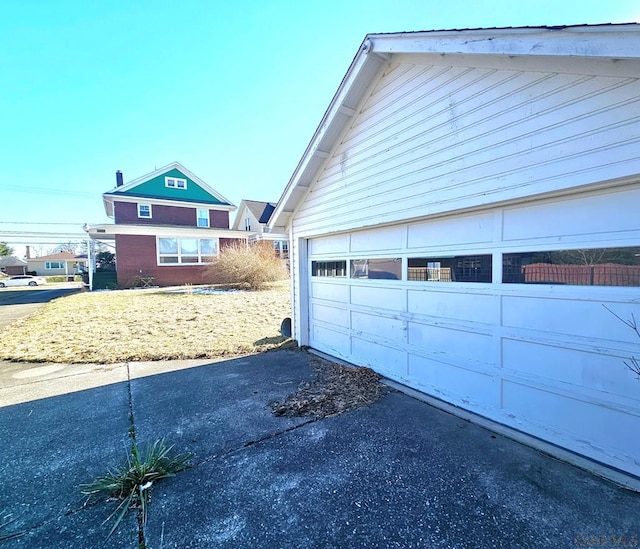 exterior space with aphalt driveway and a garage