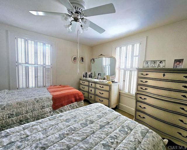 bedroom featuring ceiling fan and baseboards