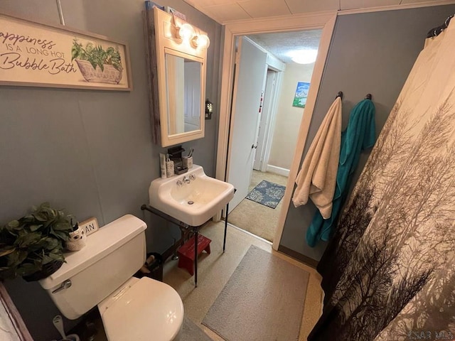 bathroom featuring a textured ceiling and toilet