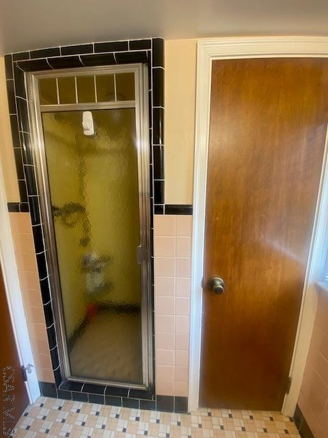 bathroom with a shower with shower door