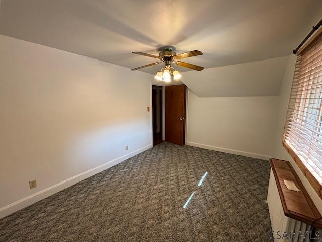 bonus room with ceiling fan, lofted ceiling, and dark carpet