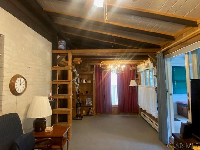 sitting room with beamed ceiling and a baseboard radiator