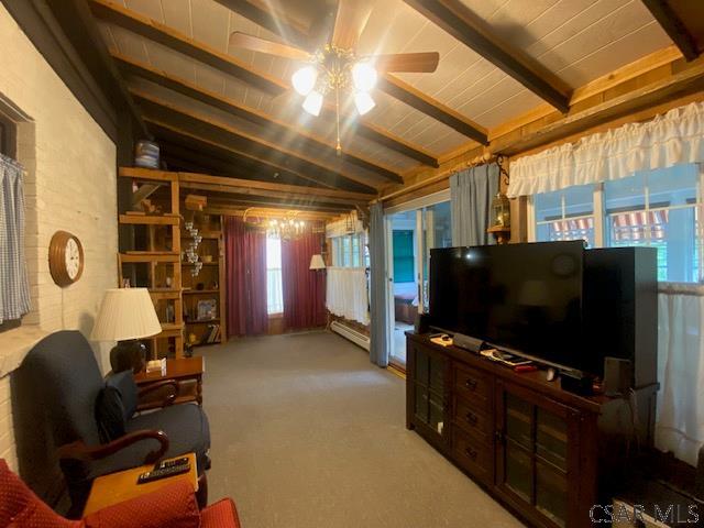 carpeted living room featuring ceiling fan, vaulted ceiling with beams, and wood ceiling