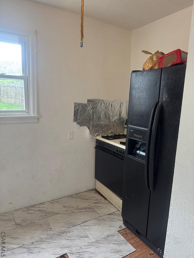 100 Cook St, Johnstown, PA 15906 - kitchen with black refrigerator with ice dispenser, white gas range oven, and light marble finish flooring