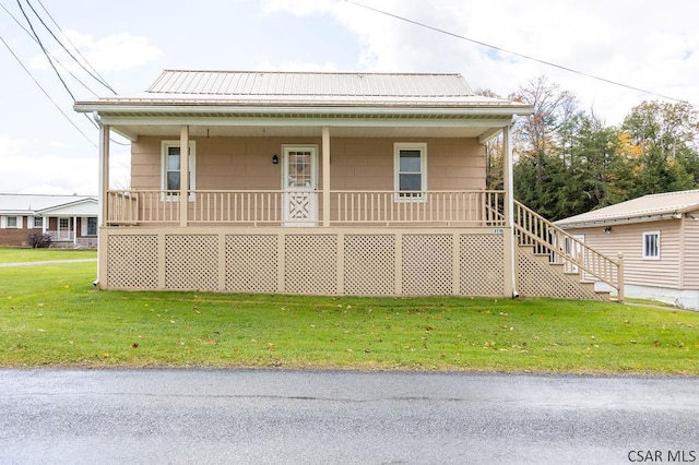 view of front of home with a front yard and covered porch