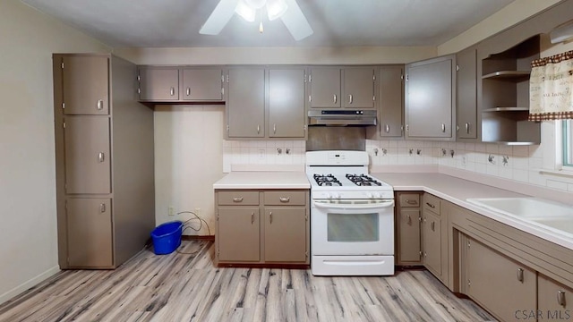 1210 Somerset Ave, Windber, PA 15963 - kitchen with white range with gas stovetop, under cabinet range hood, gray cabinets, open shelves, and light wood finished floors