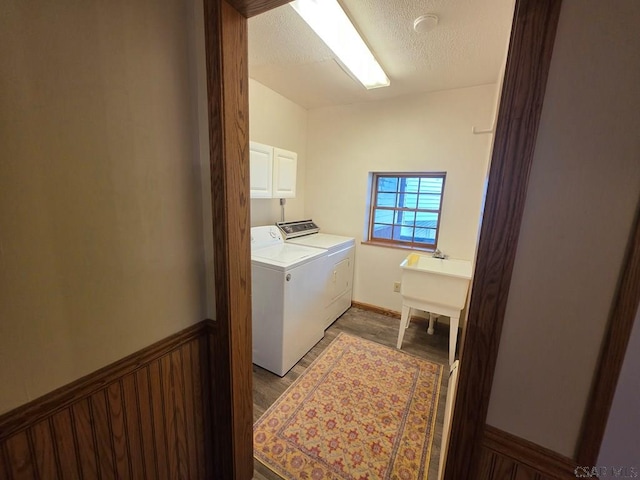 218 Center St, Meyersdale, PA 15552 - clothes washing area featuring cabinet space, washing machine and clothes dryer, a textured ceiling, and wood finished floors