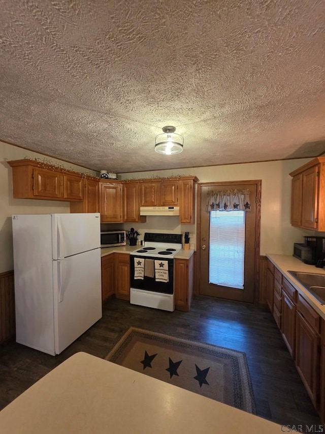 218 Center St, Meyersdale, PA 15552 - kitchen with under cabinet range hood, a textured ceiling, white appliances, and a sink