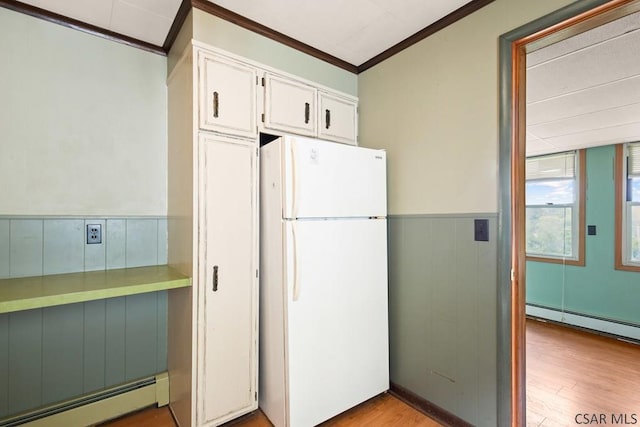 769 Russell Ave, Johnstown, PA 15902 - kitchen featuring freestanding refrigerator, a baseboard radiator, ornamental molding, white cabinets, and light wood finished floors