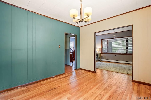 769 Russell Ave, Johnstown, PA 15902 - spare room featuring a baseboard radiator, a chandelier, crown molding, hardwood / wood-style floors, and plenty of natural light