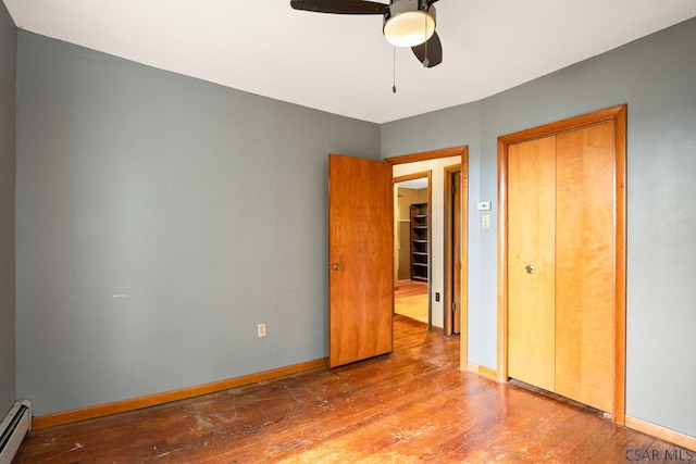 769 Russell Ave, Johnstown, PA 15902 - unfurnished bedroom featuring wood finished floors, a baseboard radiator, and a ceiling fan