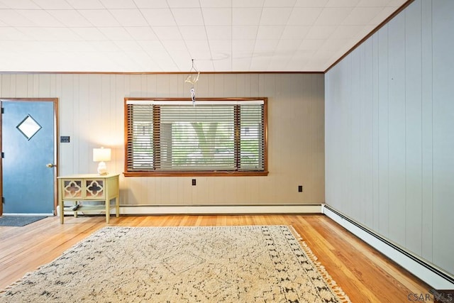 769 Russell Ave, Johnstown, PA 15902 - entryway with a baseboard heating unit, wood finished floors, and wooden walls