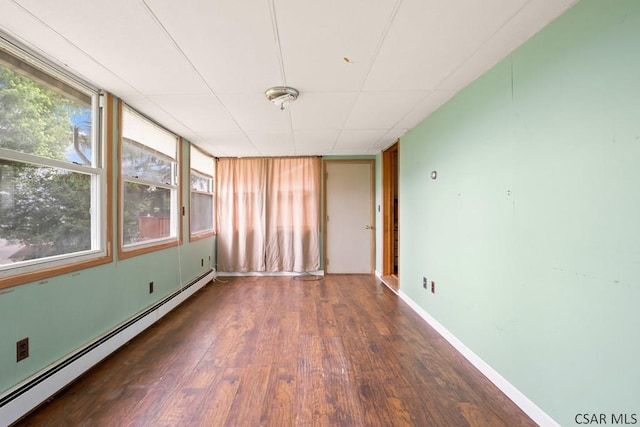 769 Russell Ave, Johnstown, PA 15902 - unfurnished room with a baseboard heating unit, wood finished floors, and plenty of natural light