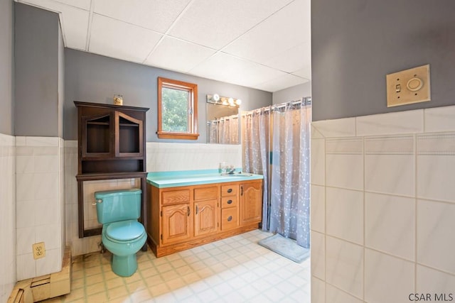 769 Russell Ave, Johnstown, PA 15902 - full bathroom with tile walls, a drop ceiling, vanity, a wainscoted wall, and a shower with curtain