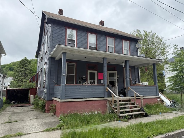 717-719 Messenger St, Johnstown, PA 15902 - view of front of property featuring a porch and a chimney