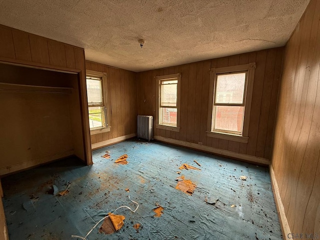 717-719 Messenger St, Johnstown, PA 15902 - unfurnished bedroom with radiator, a textured ceiling, and wood walls