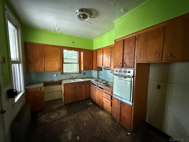 717-719 Messenger St, Johnstown, PA 15902 - kitchen with wall oven, radiator heating unit, brown cabinets, and light countertops