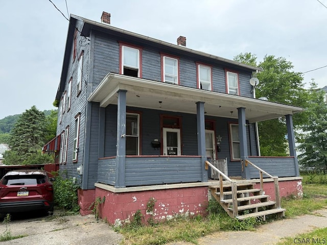 717-719 Messenger St, Johnstown, PA 15902 - view of front of house with a chimney and covered porch